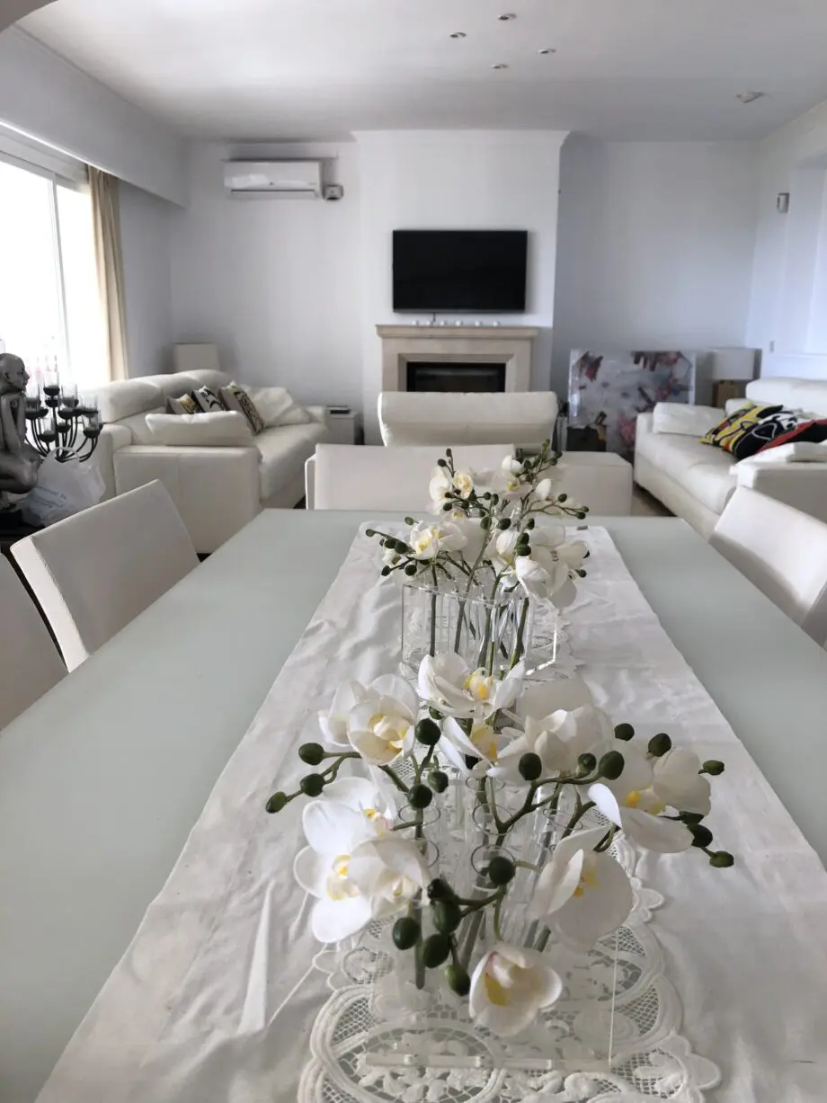 Two white leather three-seater sofas and matching reclining armchair