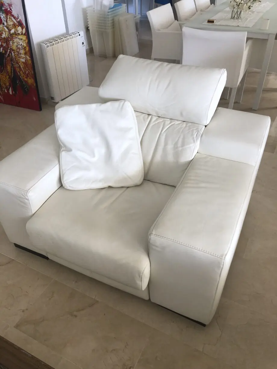 Two white leather three-seater sofas and matching reclining armchair