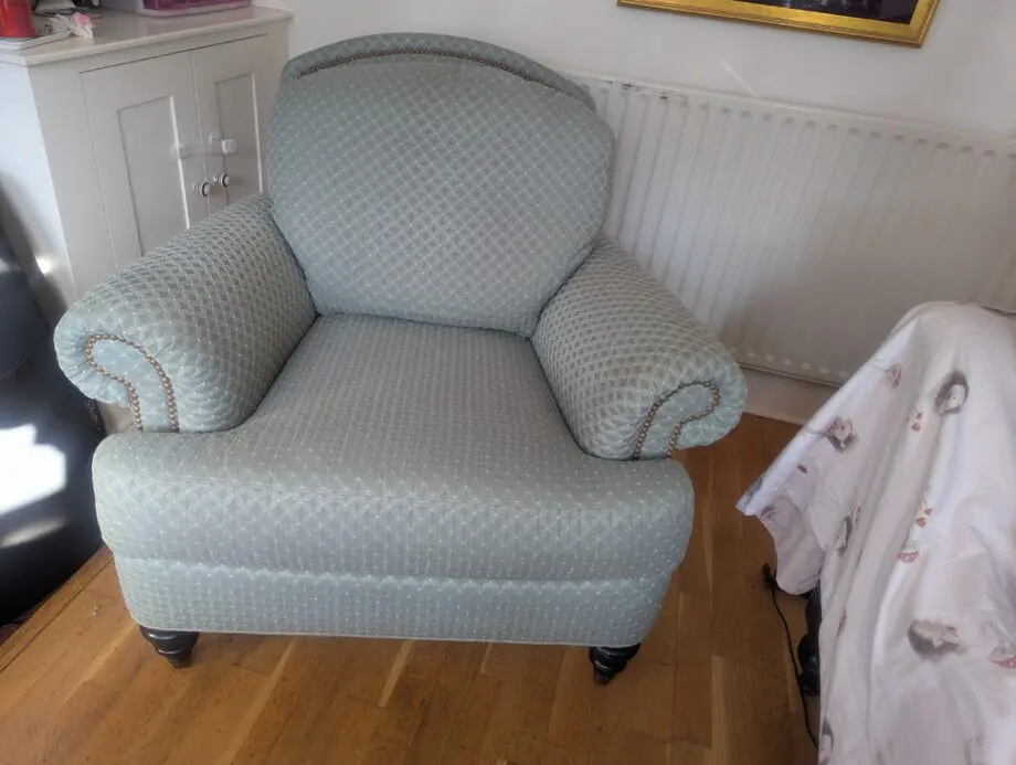 Seafoam teal overstuffed chair and footstool with nail detailing