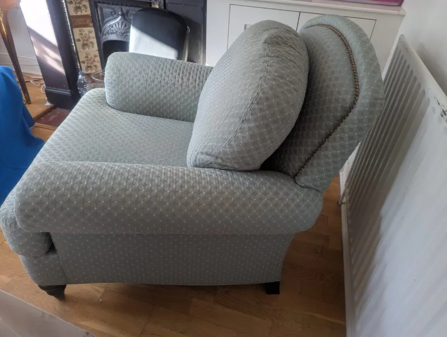 Seafoam teal overstuffed chair and footstool with nail detailing