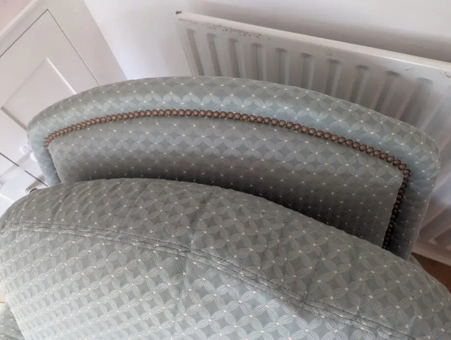 Seafoam teal overstuffed chair and footstool with nail detailing