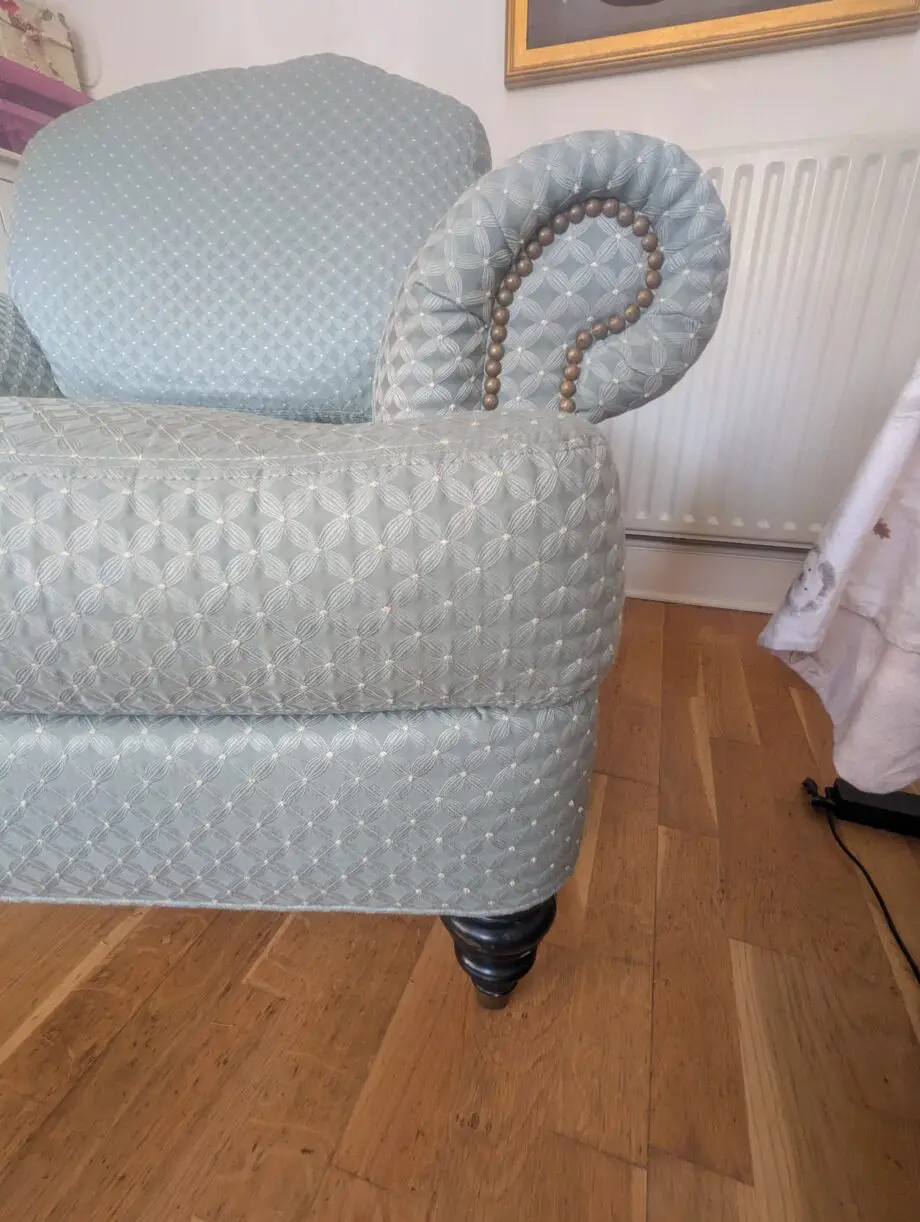 Seafoam teal overstuffed chair and footstool with nail detailing