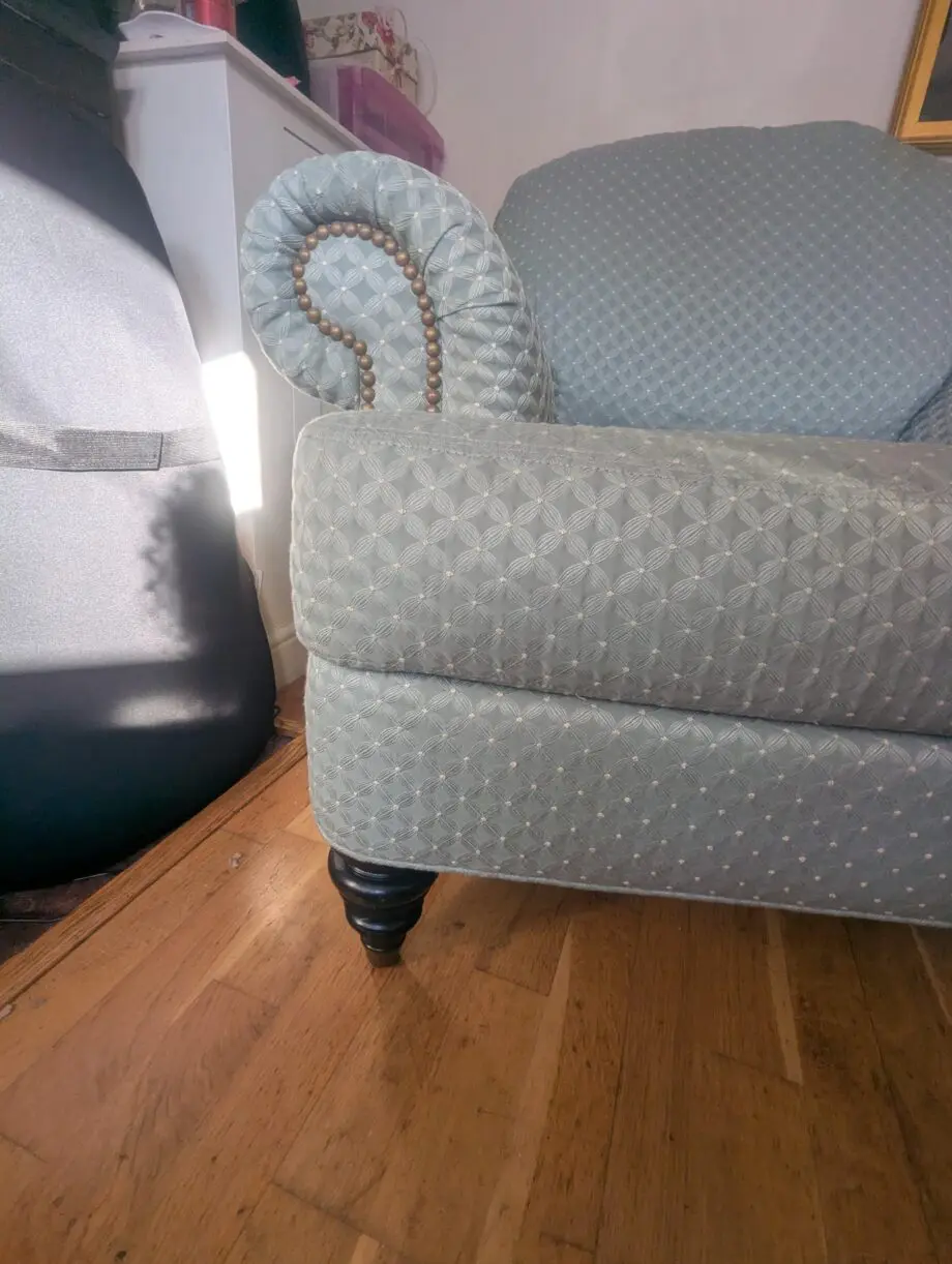 Seafoam teal overstuffed chair and footstool with nail detailing