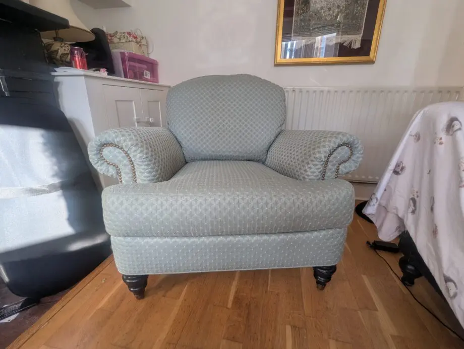 Seafoam teal overstuffed chair and footstool with nail detailing