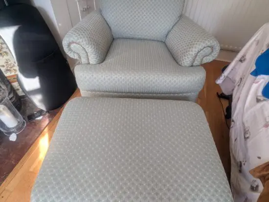 Seafoam teal overstuffed chair and footstool with nail detailing