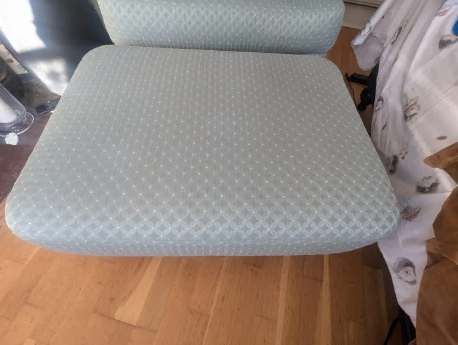 Seafoam teal overstuffed chair and footstool with nail detailing