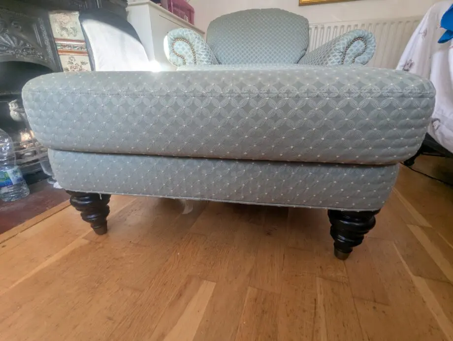 Seafoam teal overstuffed chair and footstool with nail detailing