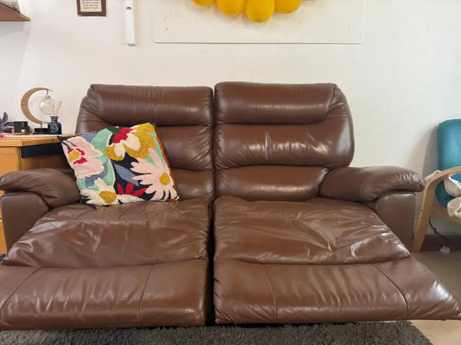 Two-seater sofa with a recliner