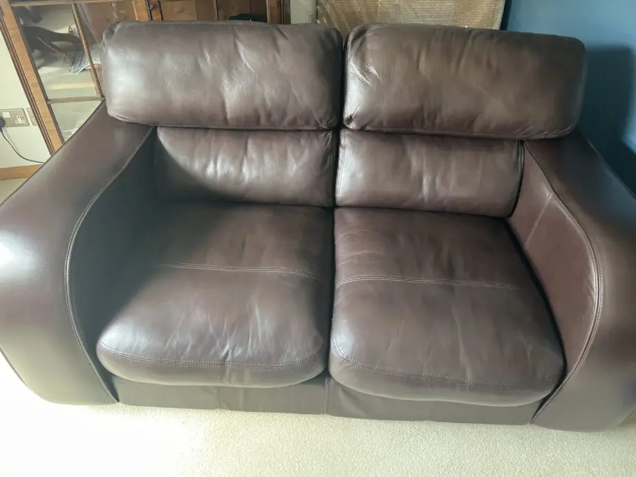 Brown leather 2 seater and matching footstool