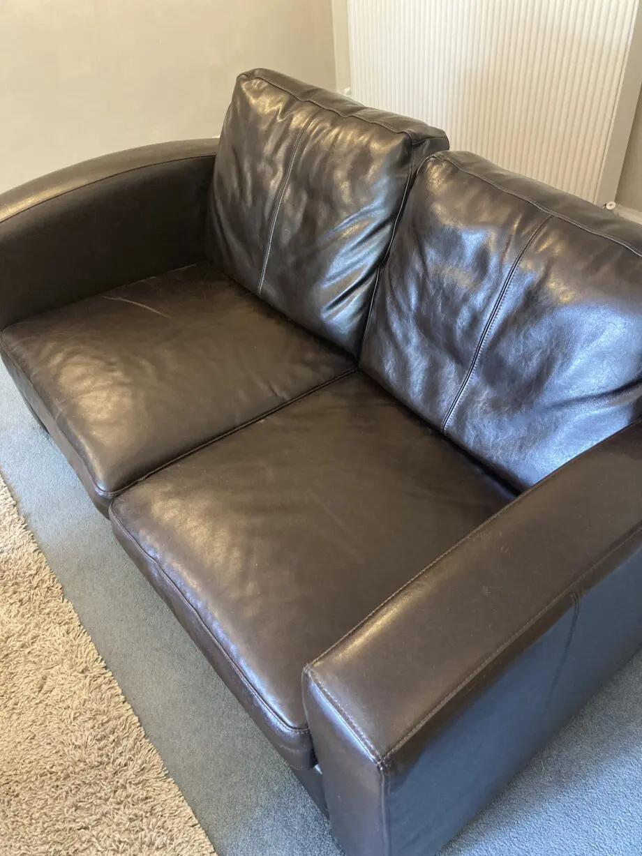 Very dark brown leather two seater matching sofas