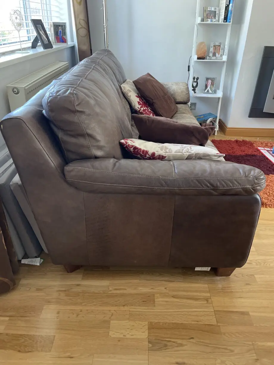 DFS - Distressed brown leather matching sofas.