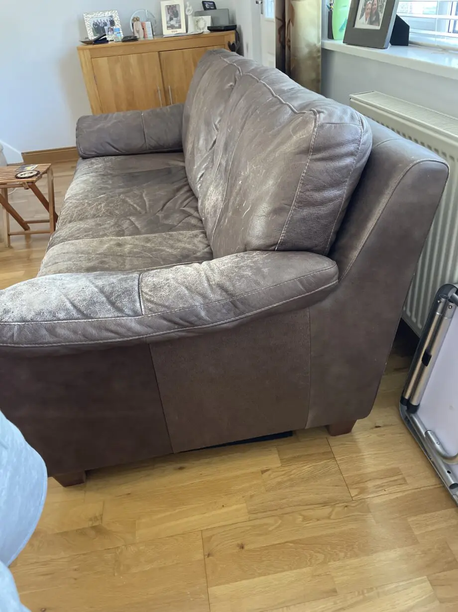 DFS - Distressed brown leather matching sofas.