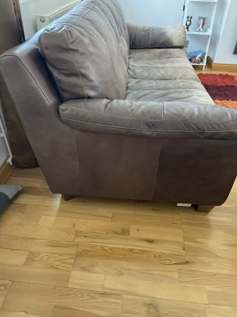 DFS - Distressed brown leather matching sofas.