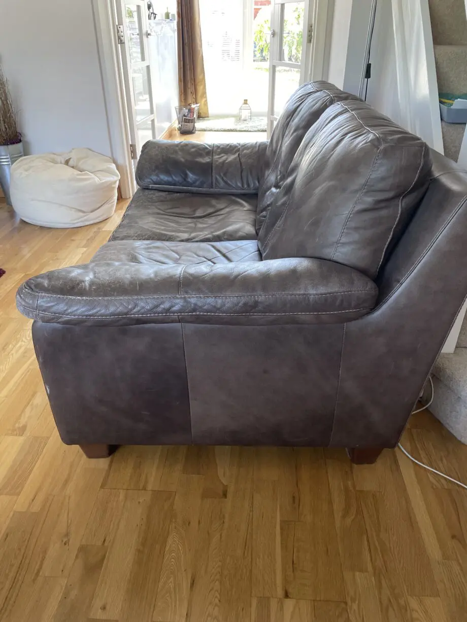 DFS - Distressed brown leather matching sofas.