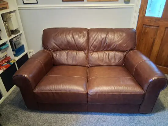 2 Dark brown DFS leather sofas plus foot stall with storage inside.