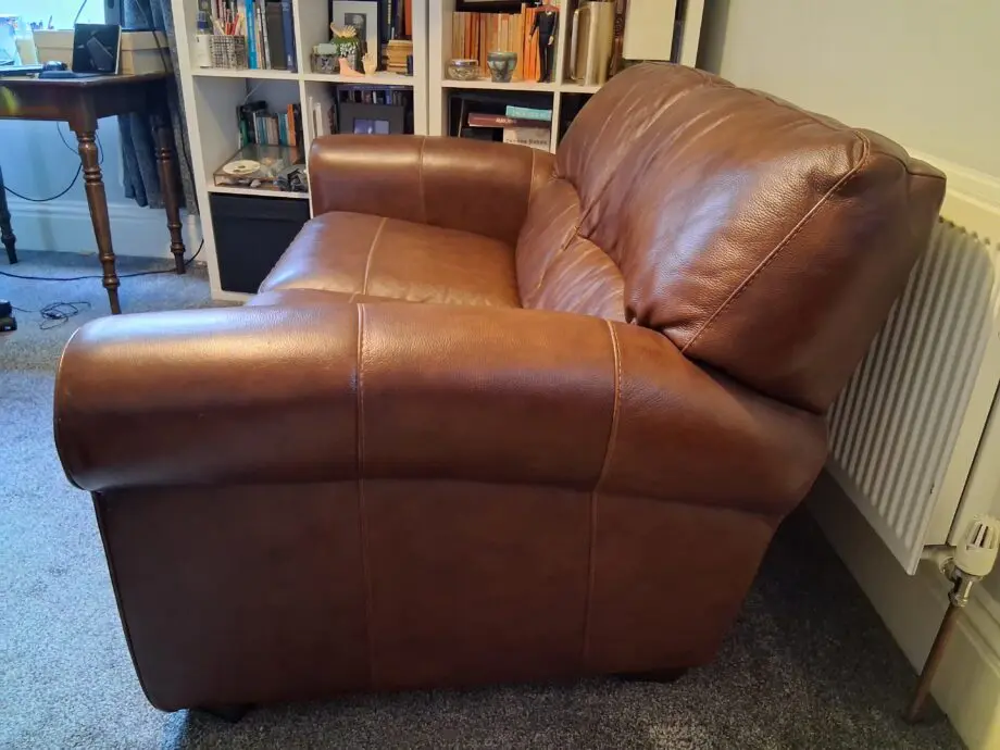 2 Dark brown DFS leather sofas plus foot stall with storage inside.