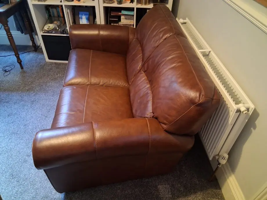2 Dark brown DFS leather sofas plus foot stall with storage inside.