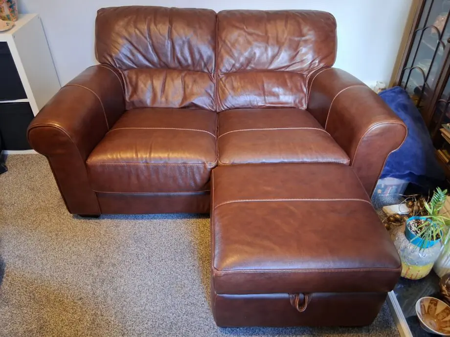 2 Dark brown DFS leather sofas plus foot stall with storage inside.