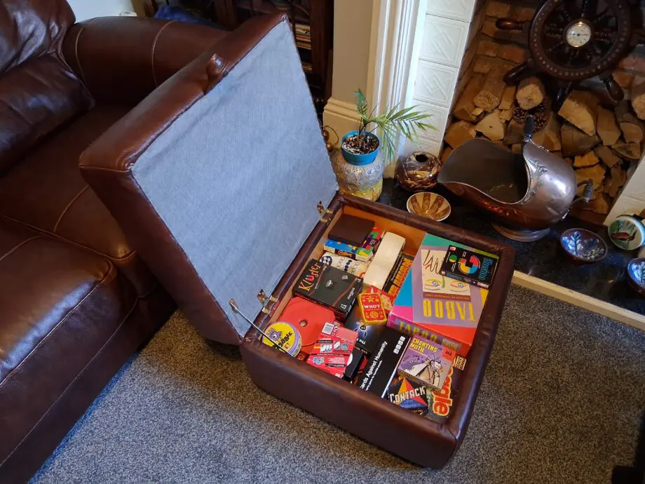 2 Dark brown DFS leather sofas plus foot stall with storage inside.