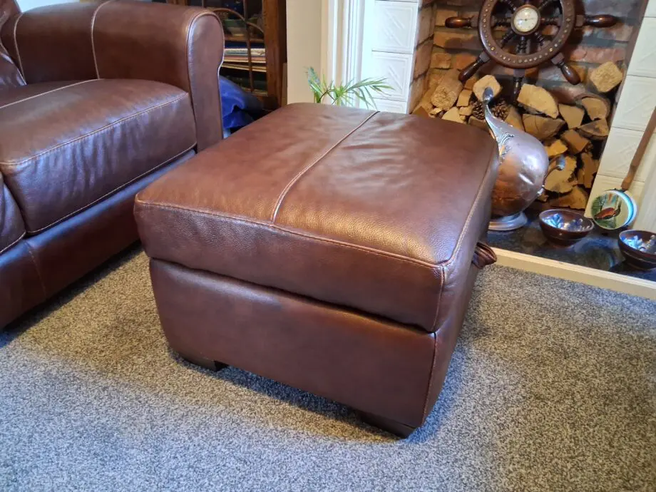 2 Dark brown DFS leather sofas plus foot stall with storage inside.