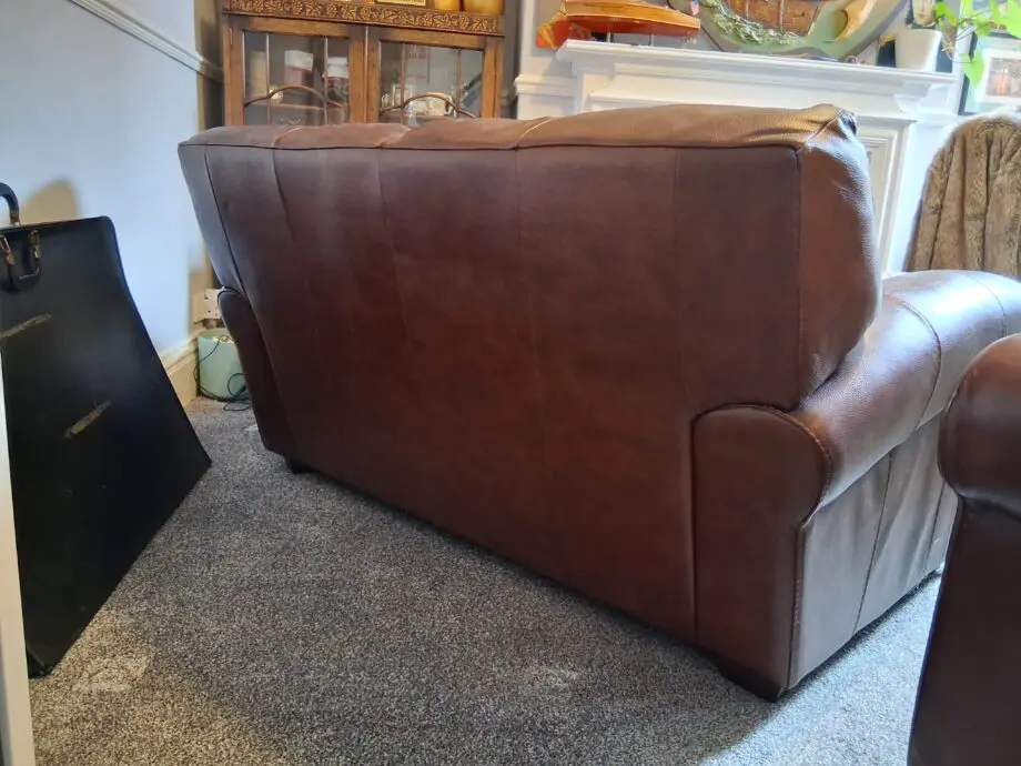 2 Dark brown DFS leather sofas plus foot stall with storage inside.