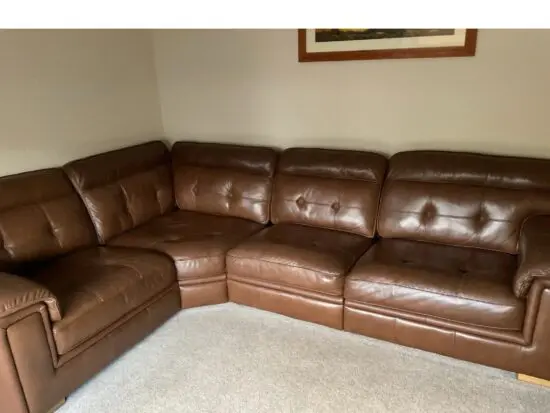 DFS deep brown leather corner sofa.