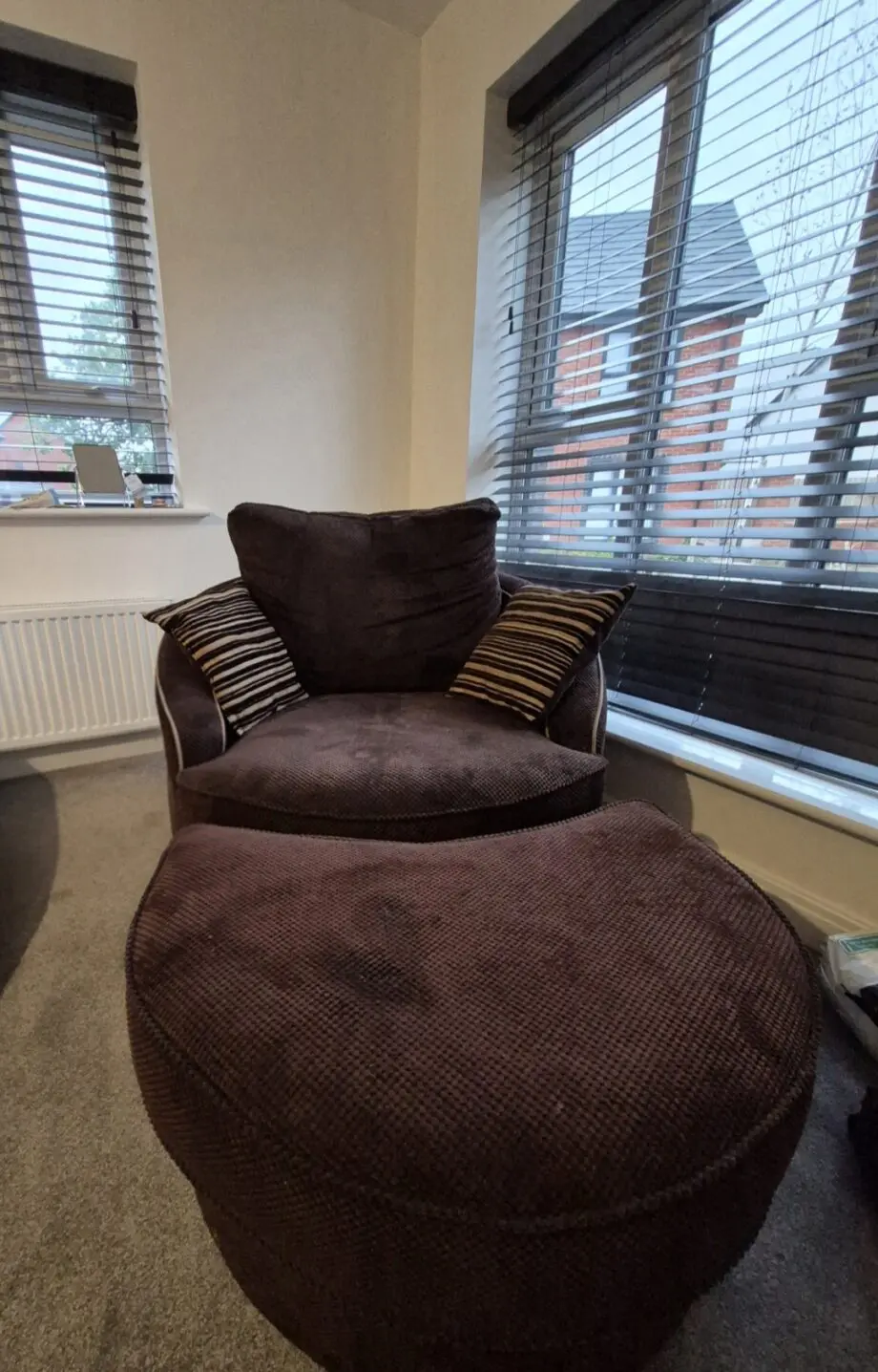 Brown and gold curved sofa, cuddle swivel chair and footstool