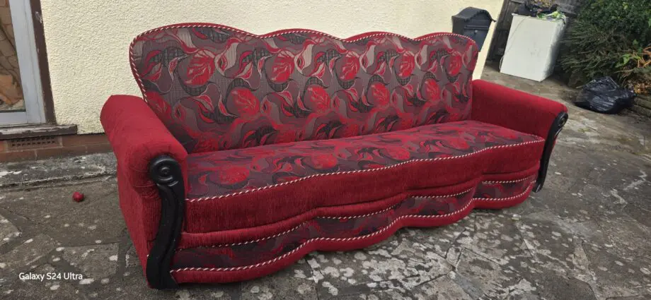 A new, burgundy-red sofa bed is available.