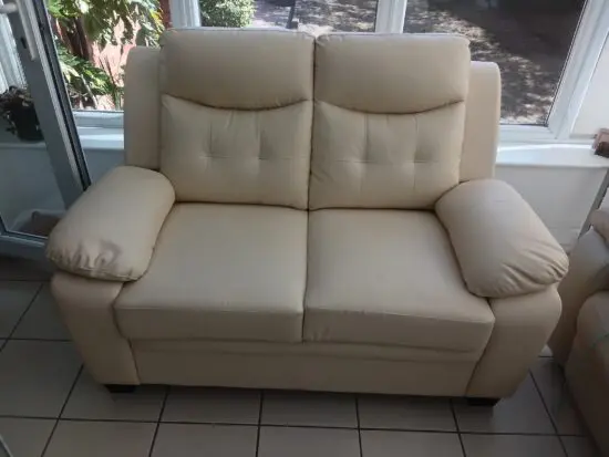 Cream 2 seater sofa - bonded leather - unused
