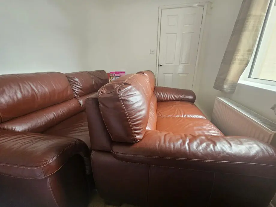 Brown 2x 2 seater leather sofas and footstool with storage
