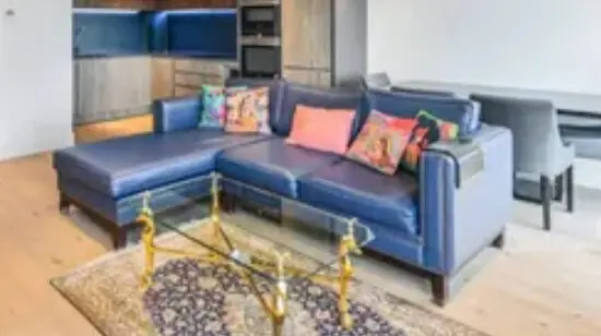 Blue made to order 3 seater sofa with antique gold stud detailing