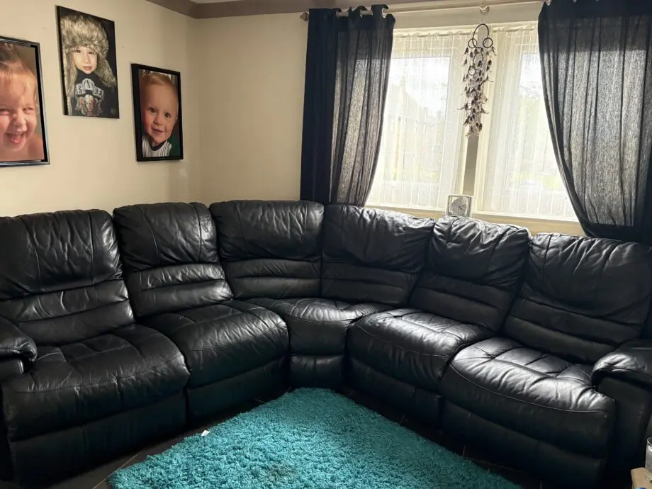 Black leather corner sofa with recliners