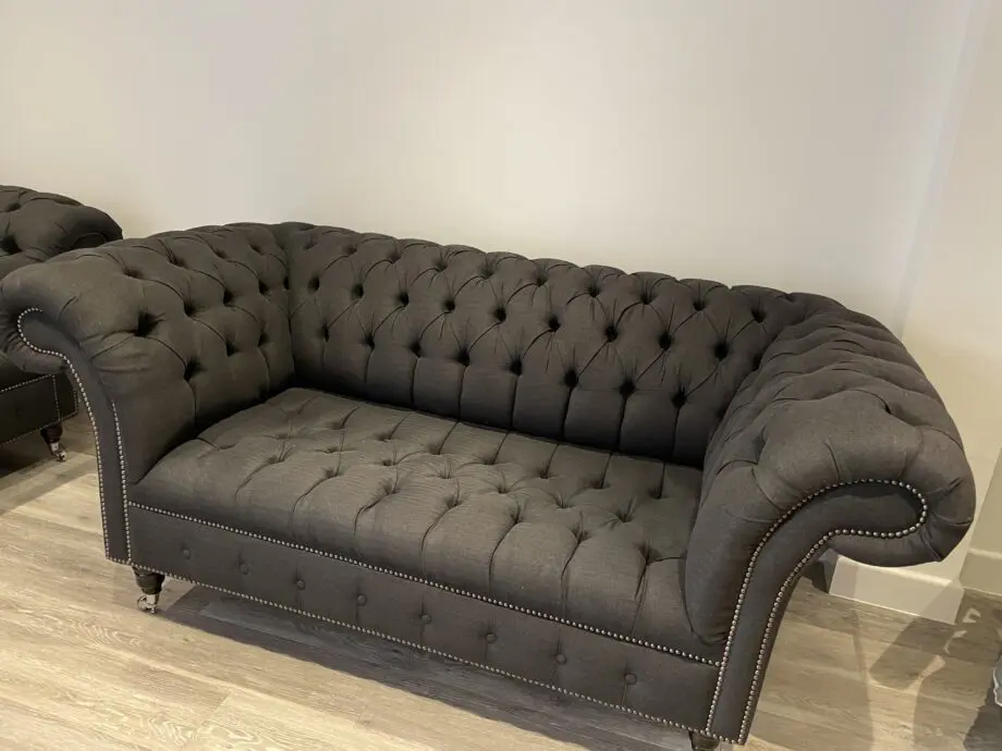 Dark grey two seater, snug chair and footstool