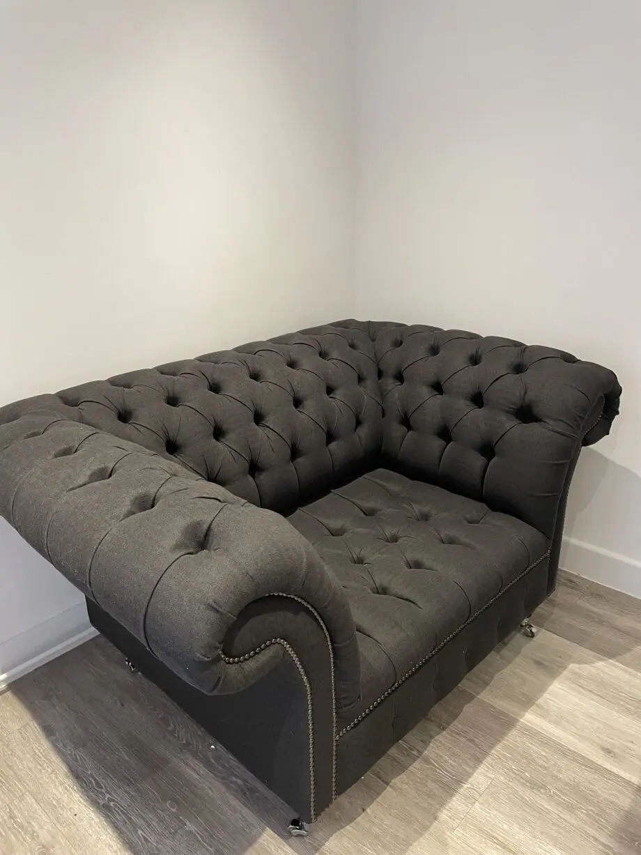 Dark grey two seater, snug chair and footstool