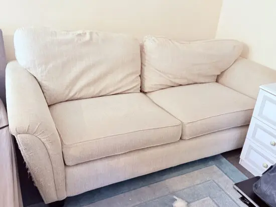 Two seater cream sofa unknown brand