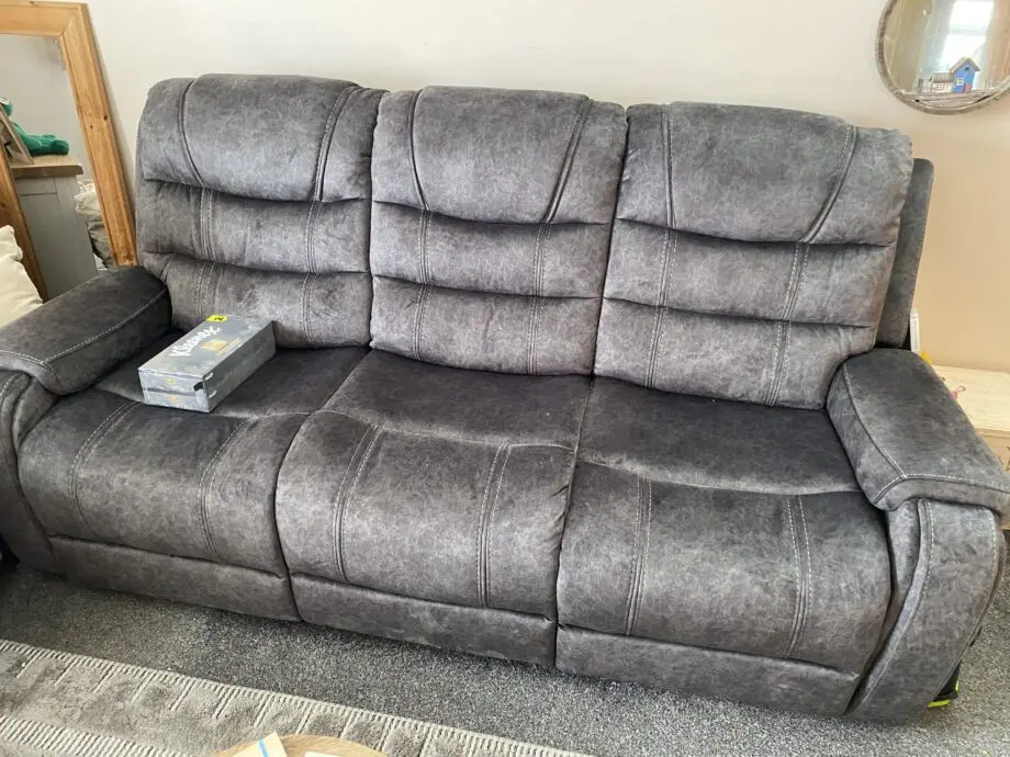 Grey three seater recliner