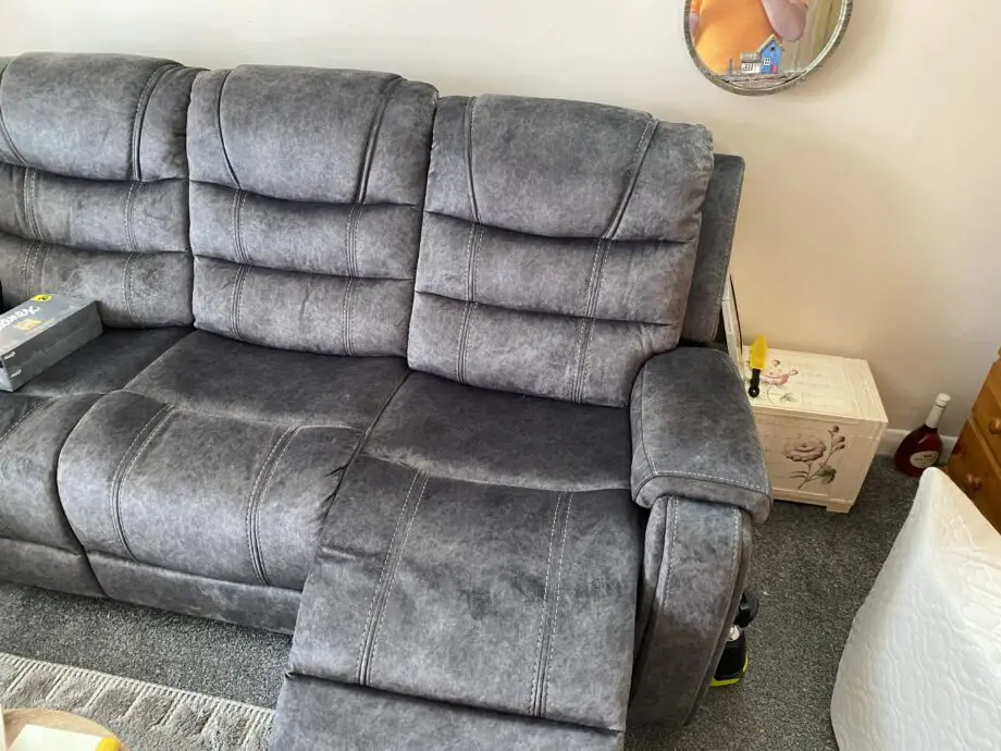 Grey three seater recliner