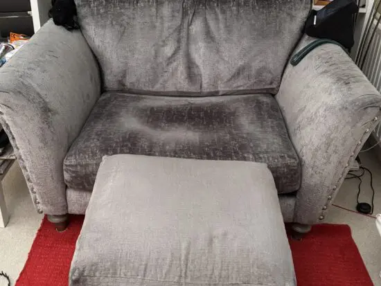 DFS Lawrie grey love armchair with matching ottoman