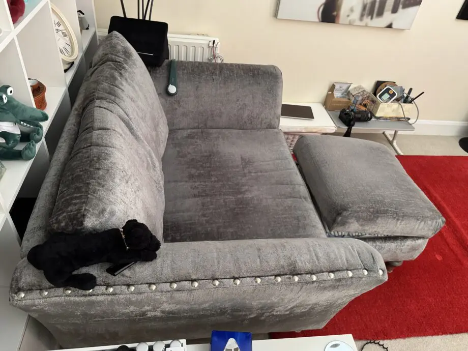 DFS Lawrie grey love armchair with matching ottoman