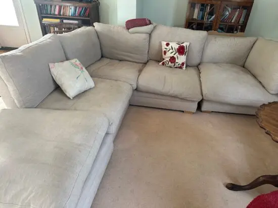 Large 4 seater sofa with backless seat which could be leg rests or table