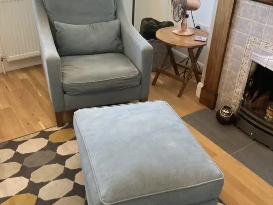 A up holstered high back easy Chair and matching foot stool
