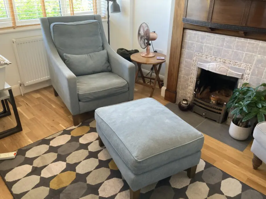 A up holstered high back easy Chair and matching foot stool