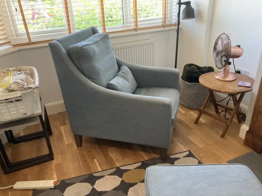 A up holstered high back easy Chair and matching foot stool