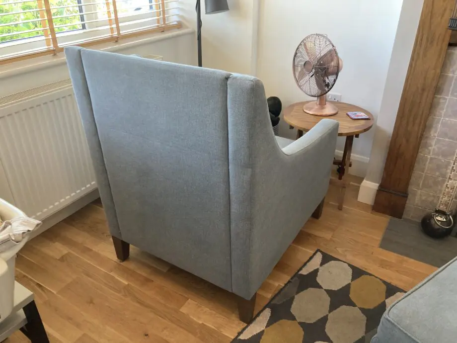 A up holstered high back easy Chair and matching foot stool