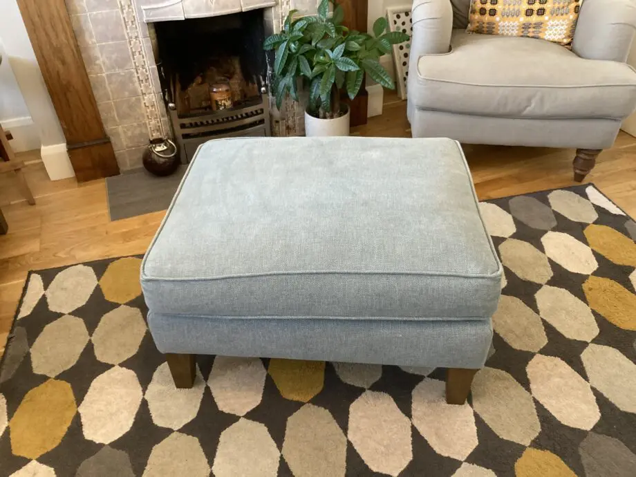 A up holstered high back easy Chair and matching foot stool