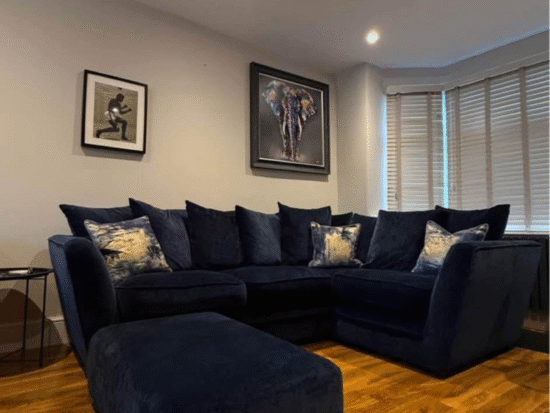 Navy corner sofa and foot stool from dfs