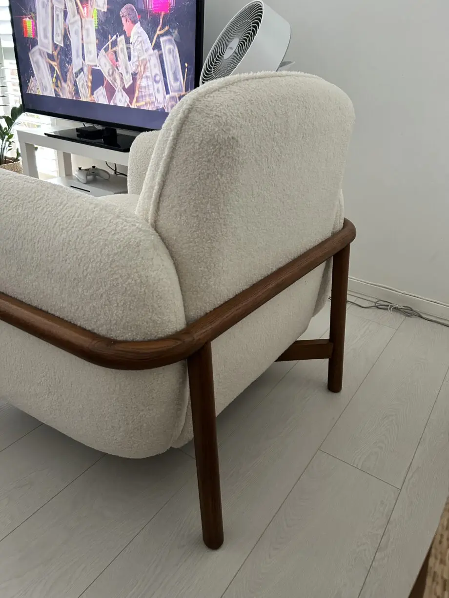Firm, cream fabric armchair with solid wood frame