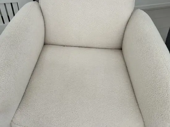 Firm, cream fabric armchair with solid wood frame