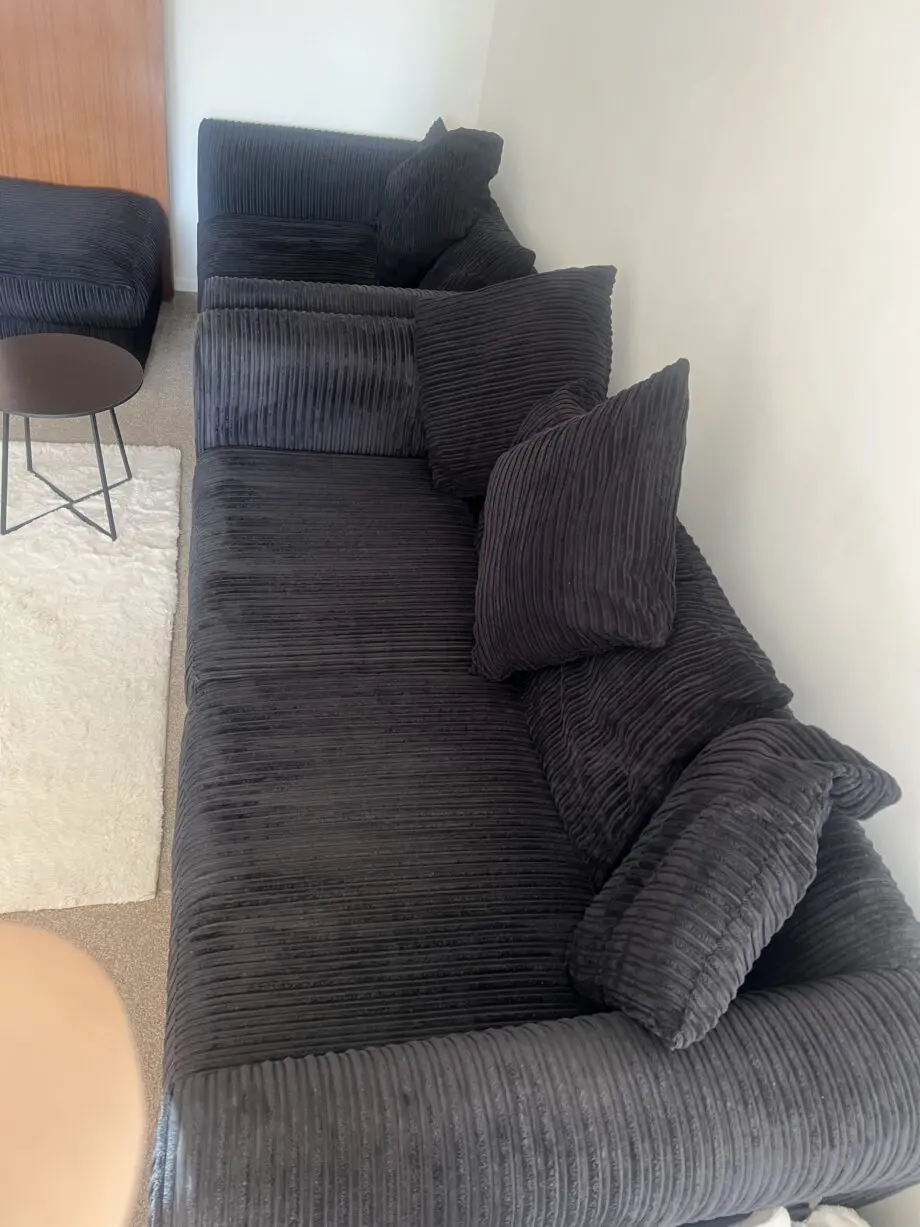 Black sofas and footstool