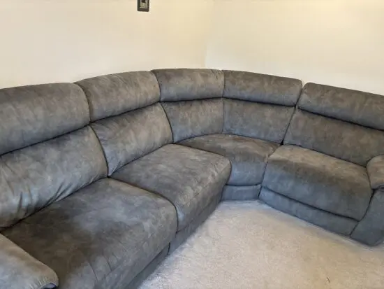 Grey l shaped recliner sofa. Oak furniture land. Only 8 months old! RRP:£2400